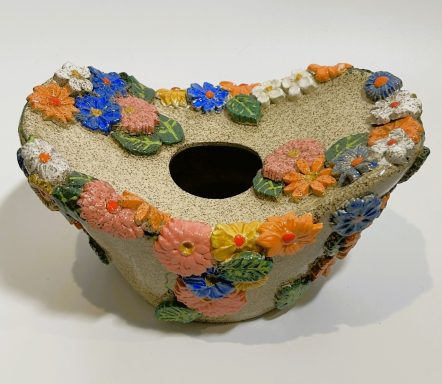 Speckled clay base vase/vessel. Hand painted porcelain flower appliques. Clear glaze coating. H-4 1/4in x W-5 3/4in x L-8 3/8in.
