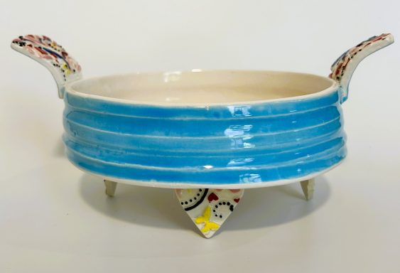 White clay base. Textured hand platter with handles and heart feet. Hand painted. H-3in x Diameter-6 3/8in.