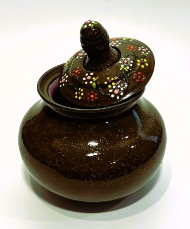 Dark brown clay base lidded vessel. Hand painted lid. Matte purple glaze interior. H-5.5in x W-4.5in.