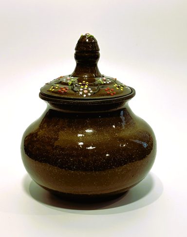 Dark brown clay base lidded vessel. Hand painted lid. Matte purple glaze interior. H-5.5in x W-4.5in.
