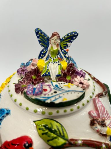 White clay base with whimsical hand built & hand painted appliques. Inner sky blue and greed glaze. External clear glaze coating.
