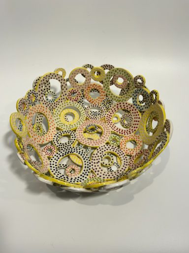 White clay base. Hand built. Hand painted layered circles. Yellow and white external glaze. H-3.5in x Diameter-10in.