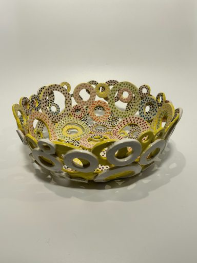 White clay base. Hand built. Hand painted layered circles. Yellow and white external glaze. Measurements: H-3.5in x Diameter-10in.