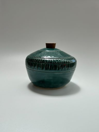 White clay body. Emerald green glaze exterior. White glaze interior. Chattering detailing. H-3 7/8in x W-4.5in.