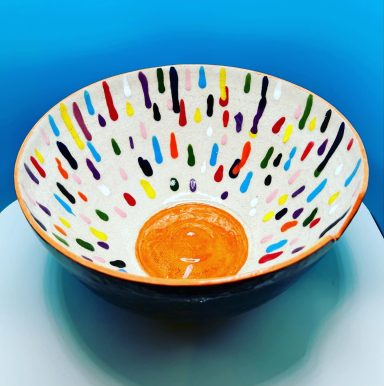 White clay body. Jungle Gems glaze outside. Hand painted colorful inside.