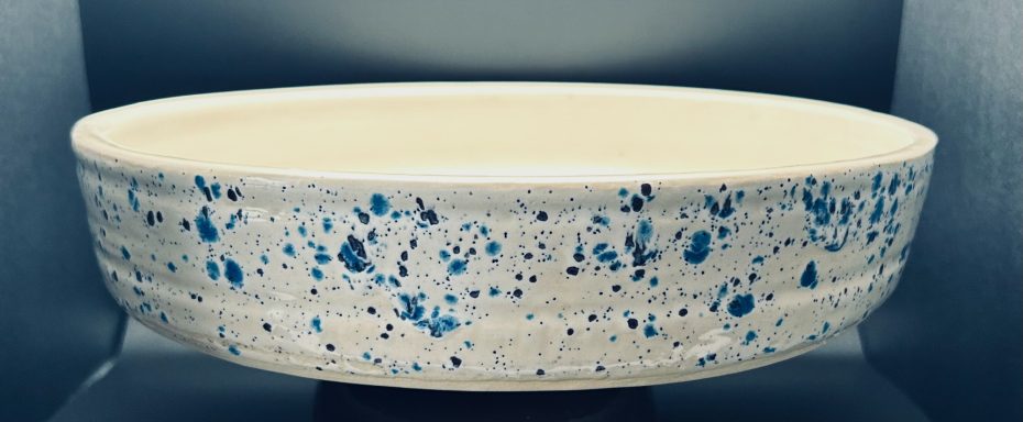 White clay body. Wheel and slab built. Jungle Gems external glaze. Internal hand painted textured base. Measurements: H-2in x Diameter-11in.