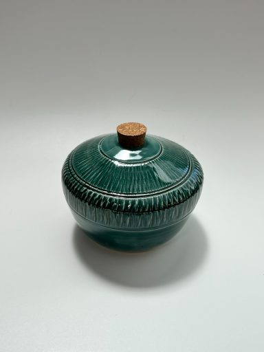 White clay body. Emerald green glaze exterior. White glaze interior. Chattering detailing. H-3 7/8in x W-4.5in.