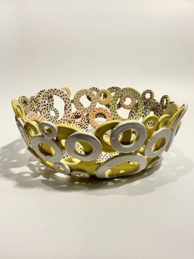 White clay base. Hand built. Hand painted layered circles. Yellow and white external glaze. H-3.5in x Diameter-10in.